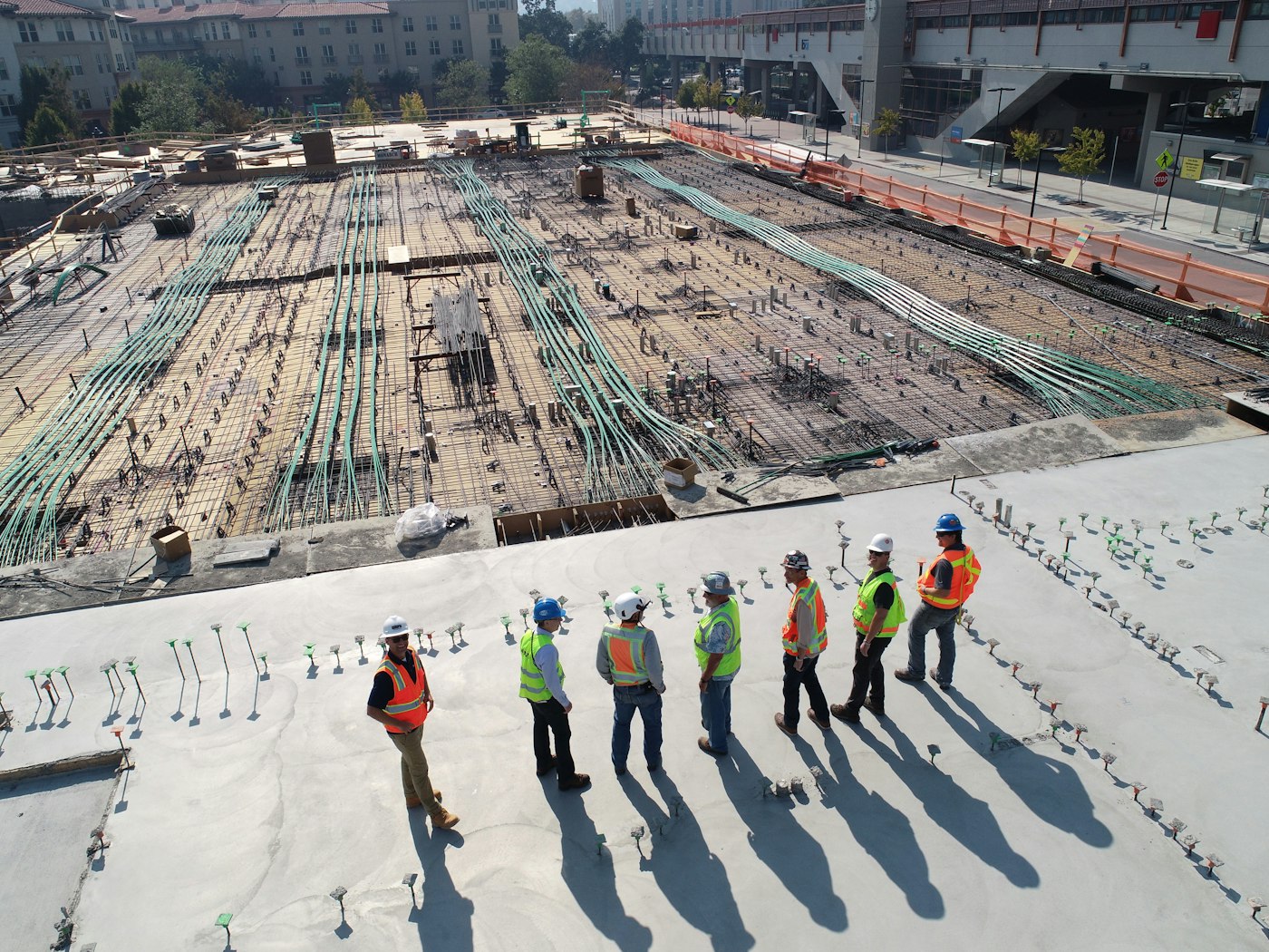 A crew of workers in high-vis gear lined up at a job site